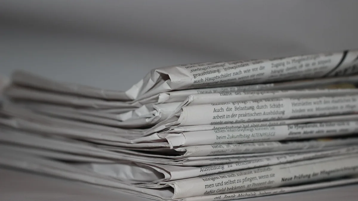 A close up image of folded newspapers perfect for news o