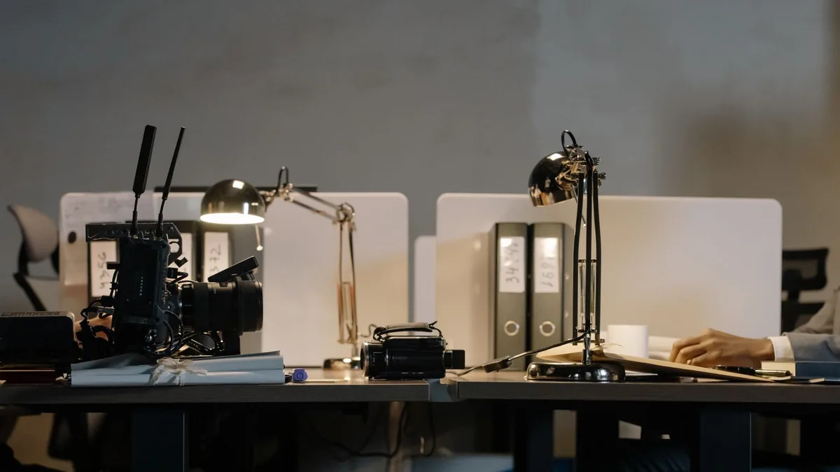 A contemporary office setup featuring desks with lamps a