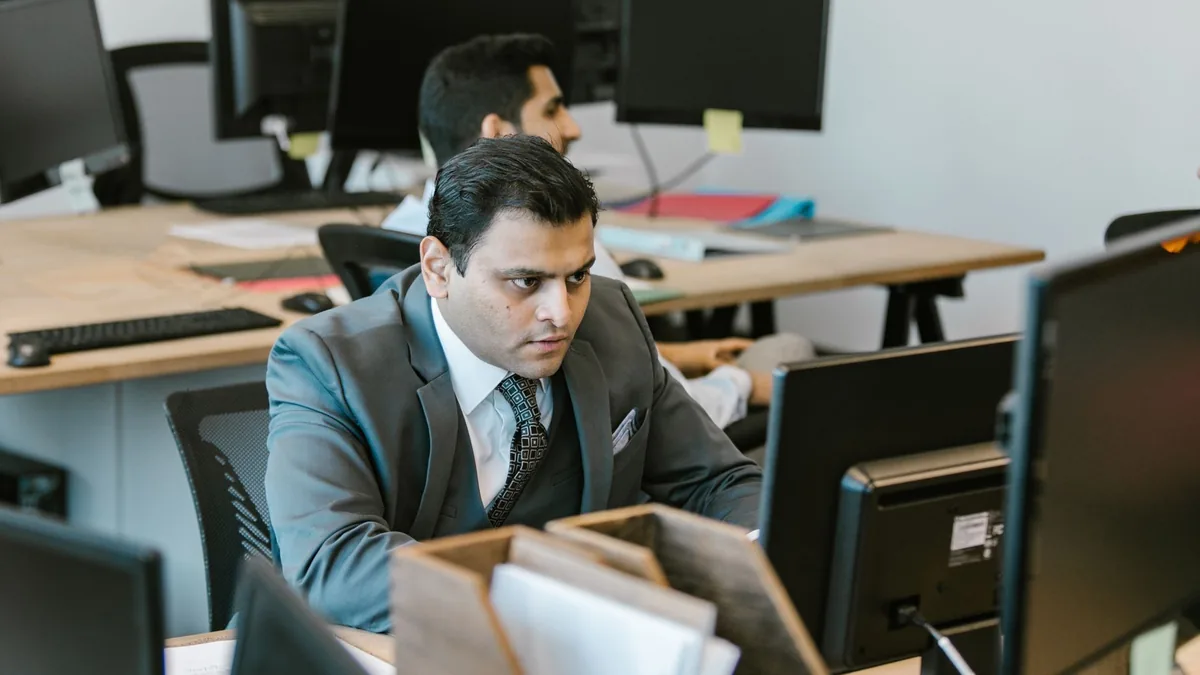 A dedicated businessman in a suit concentrating on work