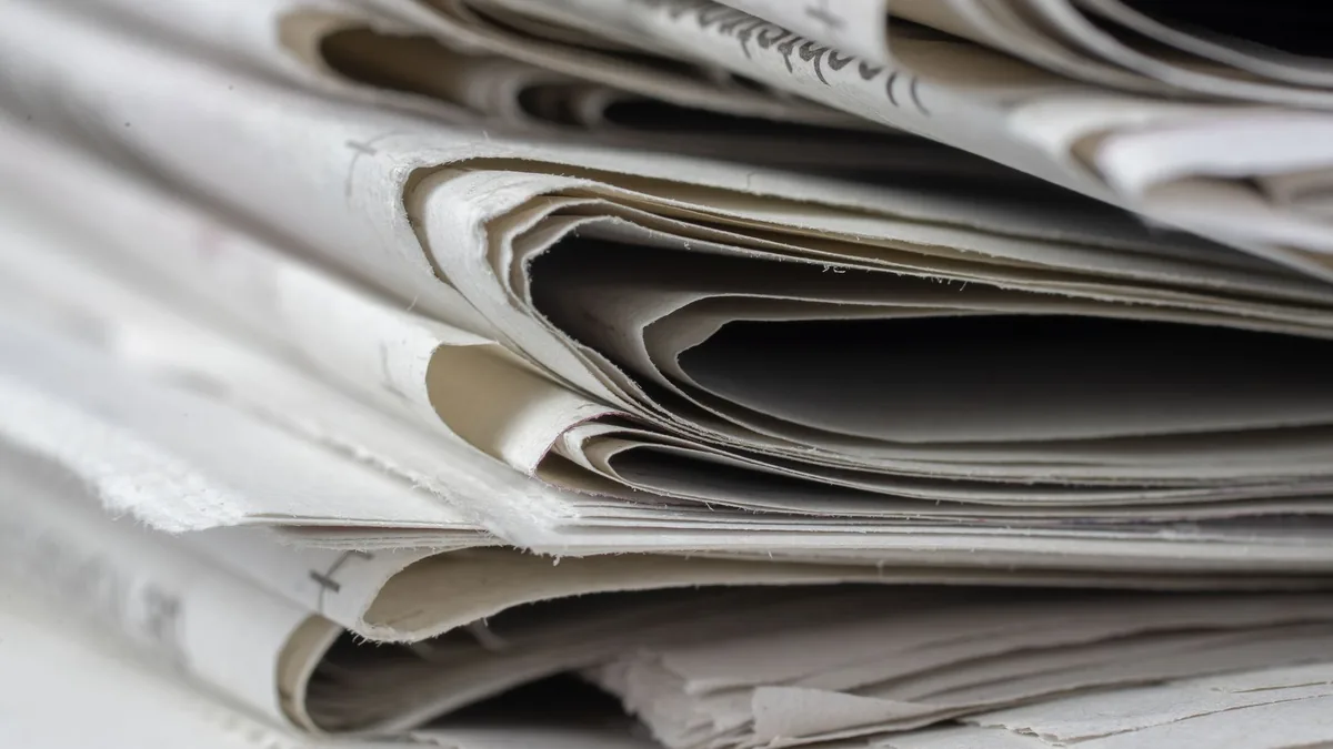 A detailed close up view of stacked newspapers highlight