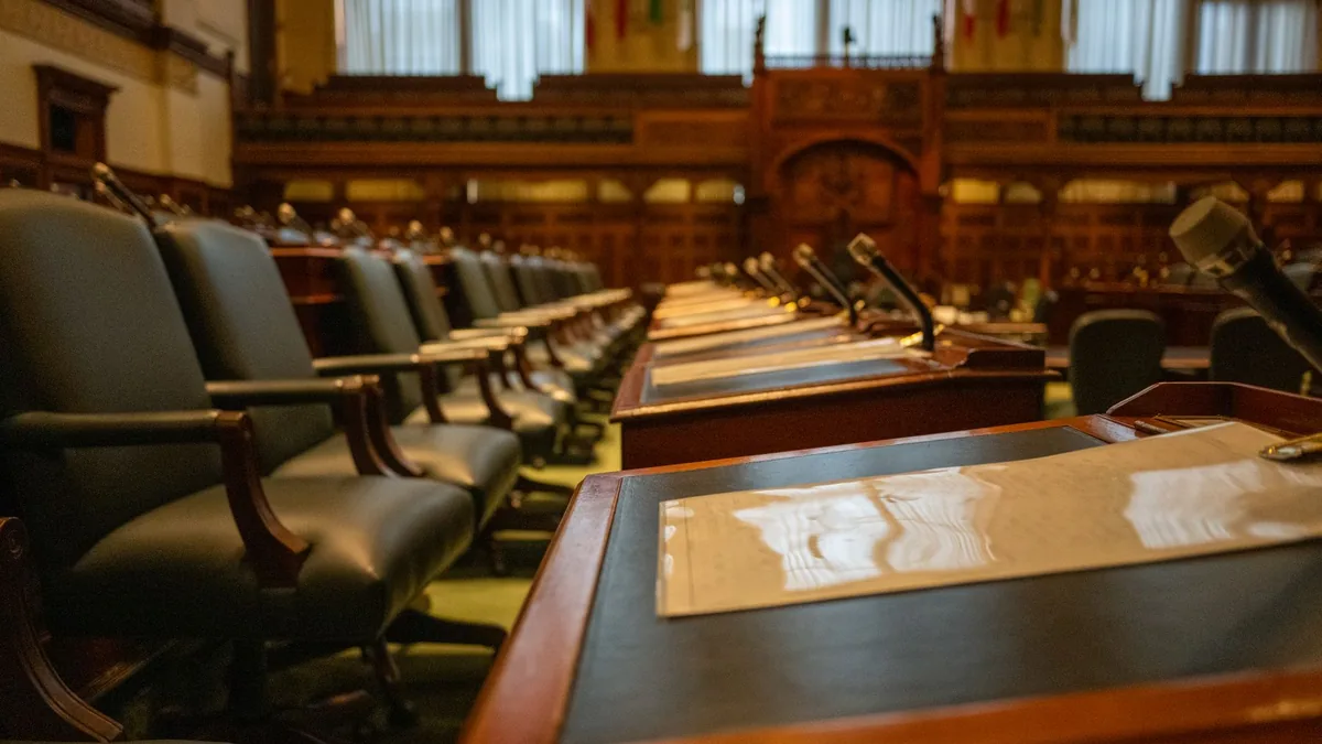 A detailed view of an empty legislative chamber with row
