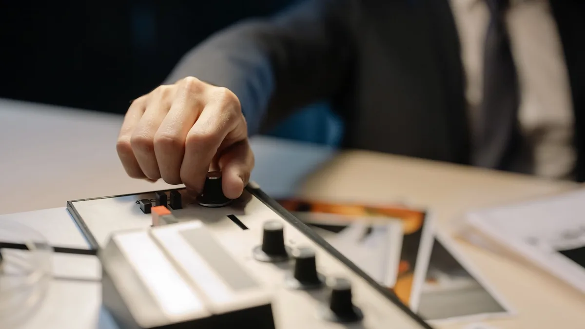 A detective s hand adjusts knobs on a vintage tape recor
