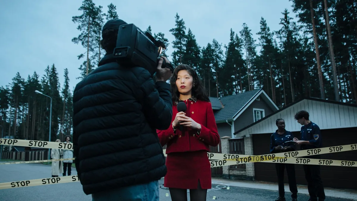 A female journalist reports live from an outdoor crime s