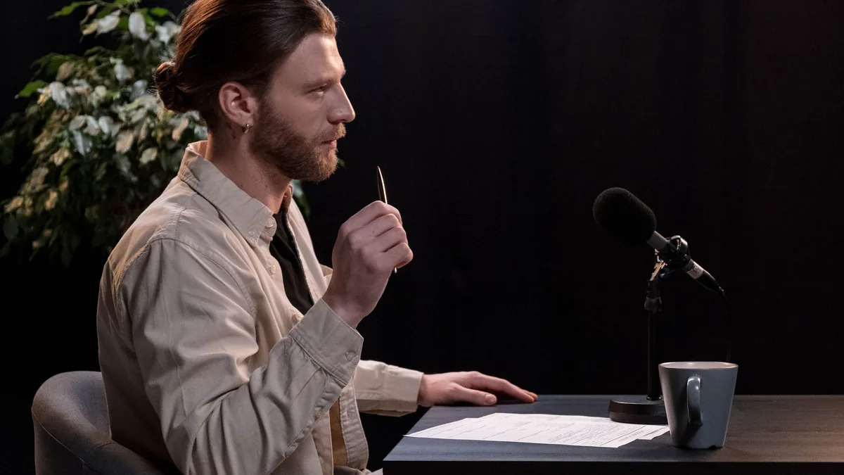 A man recording a podcast in a professional studio envir