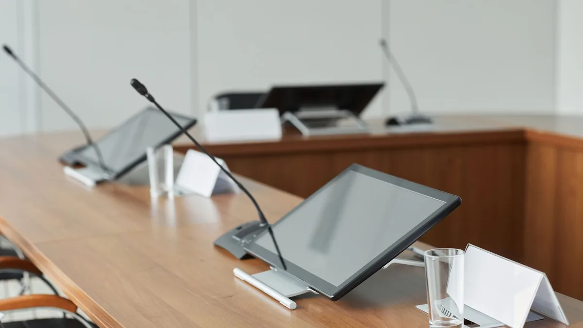 A modern conference room featuring sleek monitors and mi