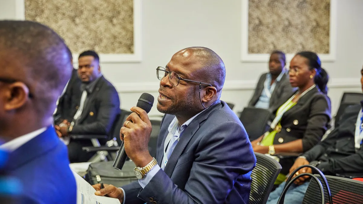 A participant in a suit asks a question during a profess