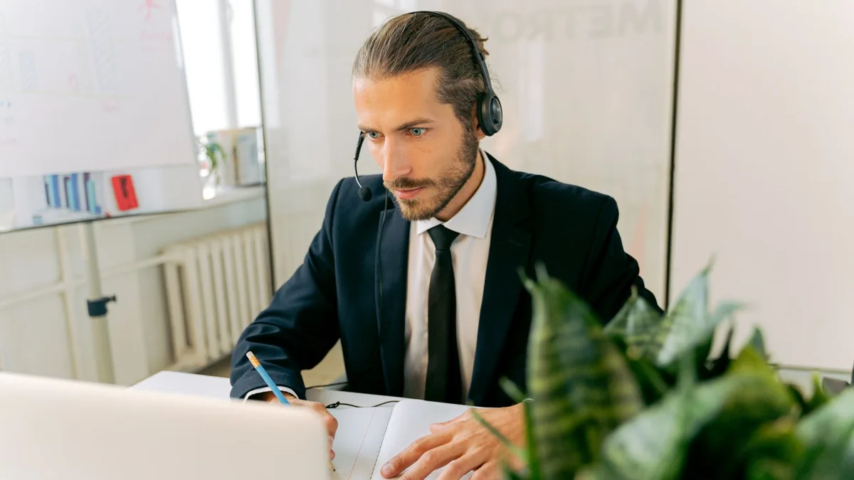 A professional customer service agent focuses intently w
