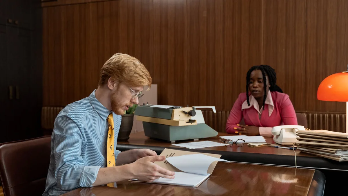 A professional discussion in a vintage office setting fe