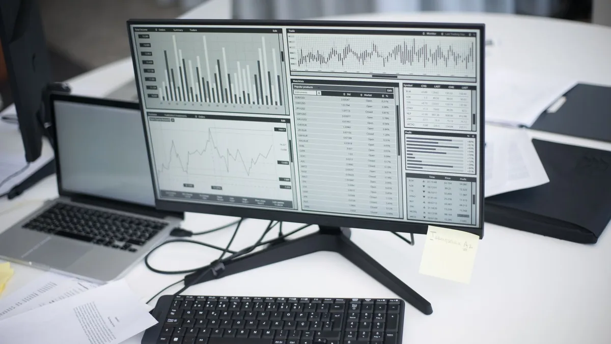 A professional workspace featuring computers and analyti