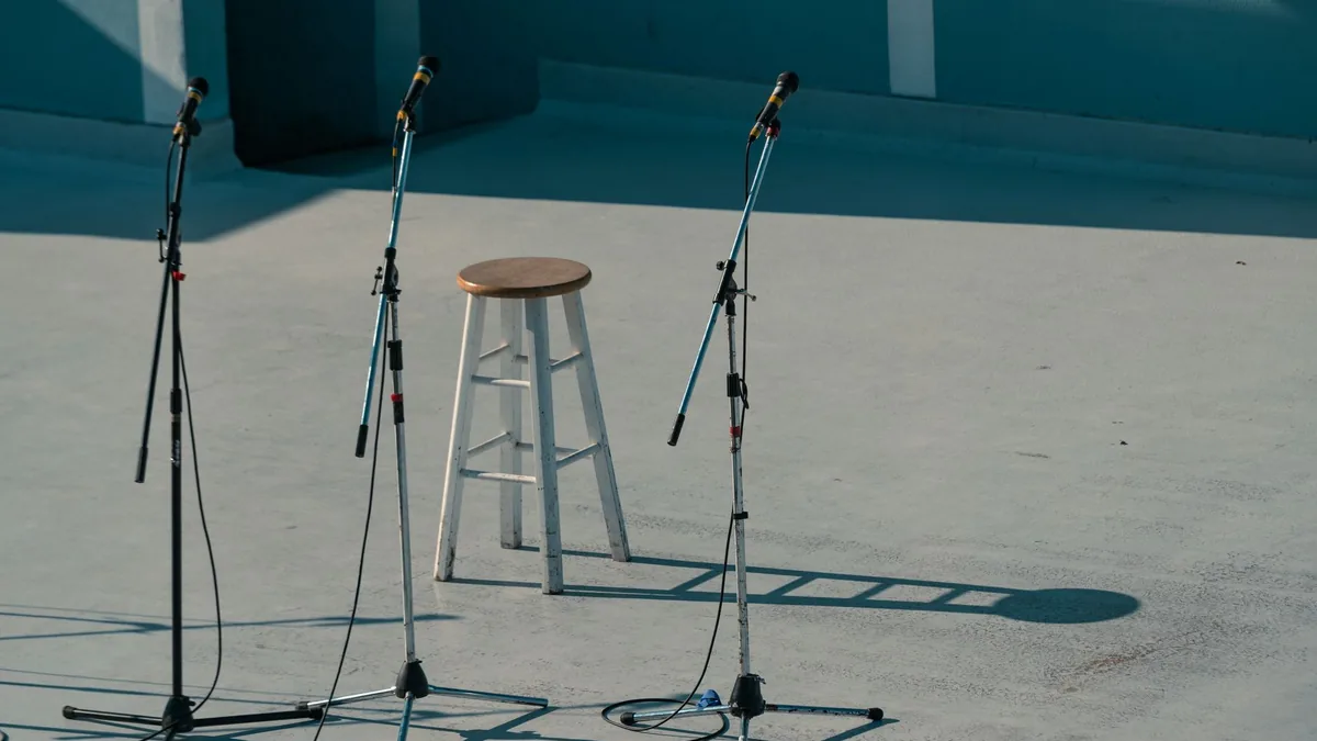 A serene outdoor stage setup featuring a bar stool and m