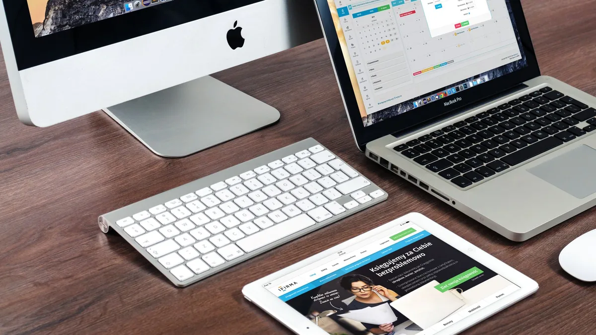 A sleek office desk setup featuring apple devices imac m