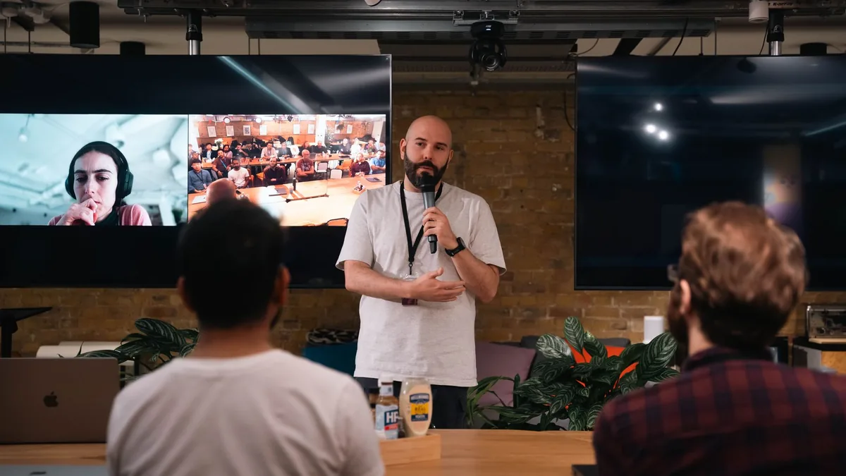 A speaker delivers a presentation at a tech conference w