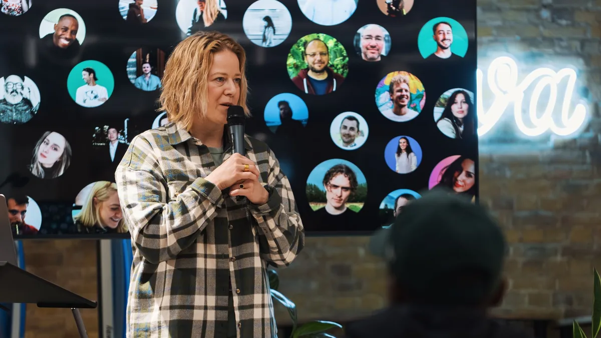 A speaker presenting at a conference indoors with audien
