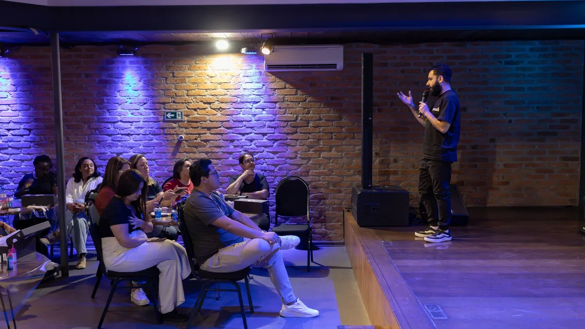 A speaker presents to an attentive audience in a modern