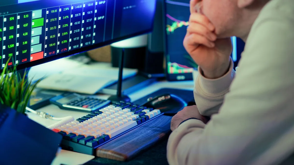 A stock trader intensely analyzing financial market data