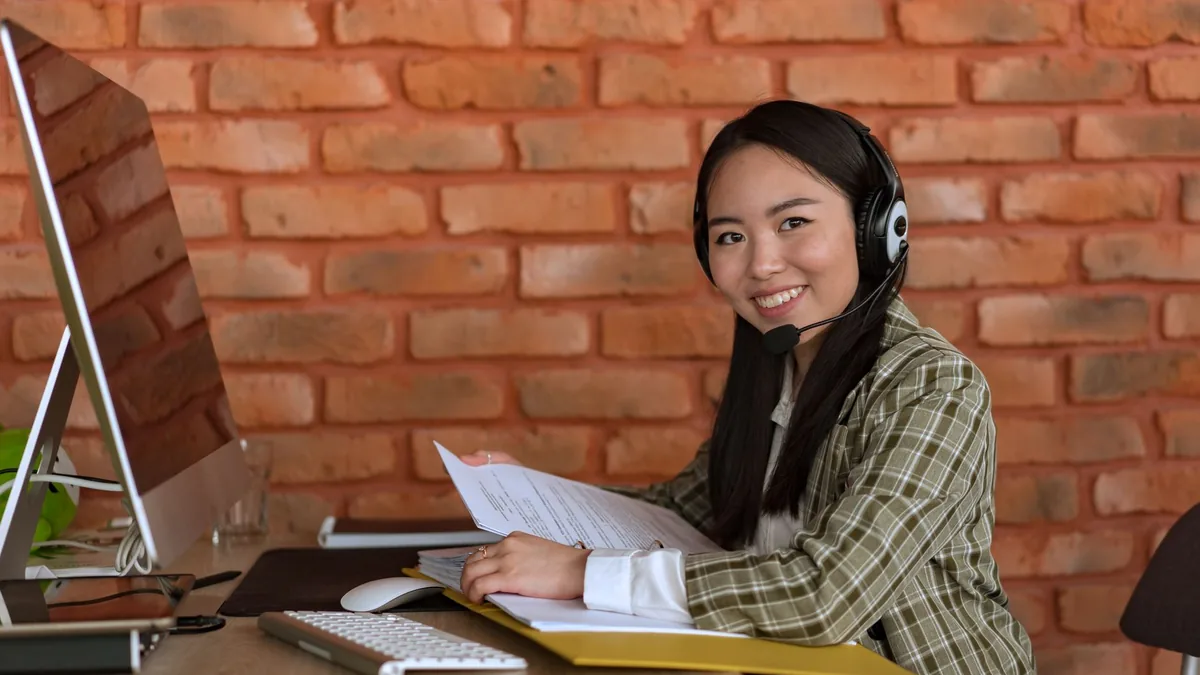 A woman working as a call center agent sitting at a desk