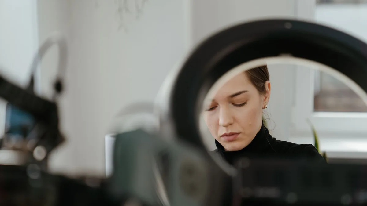 A woman works intently in a modern studio surrounded by