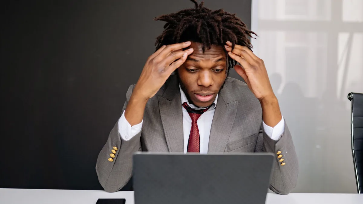 African american businessman experiencing stress while w