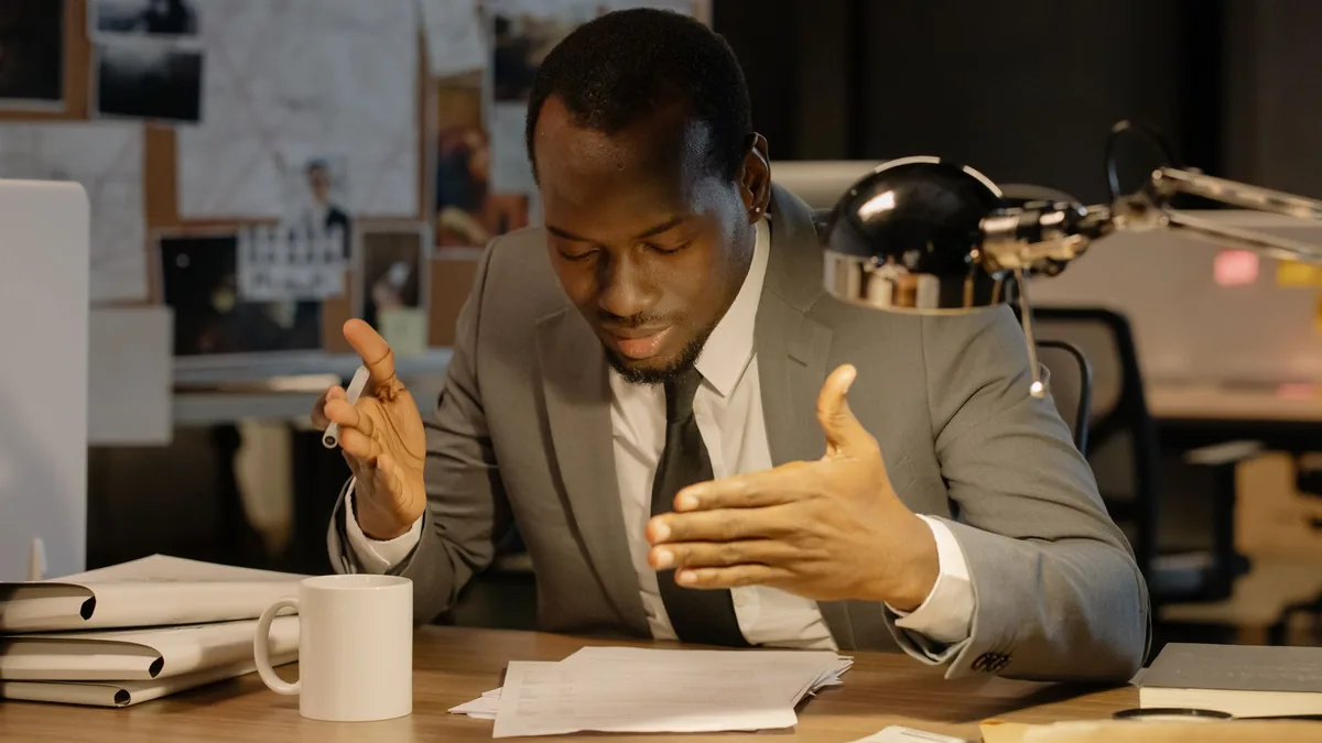 African american man in a gray suit reviewing papers at