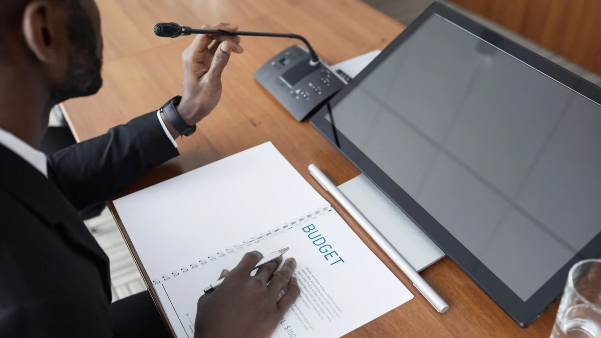 African american man in a meeting reviewing a budget doc