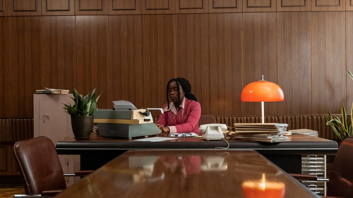 African american woman typing on an antique typewriter i