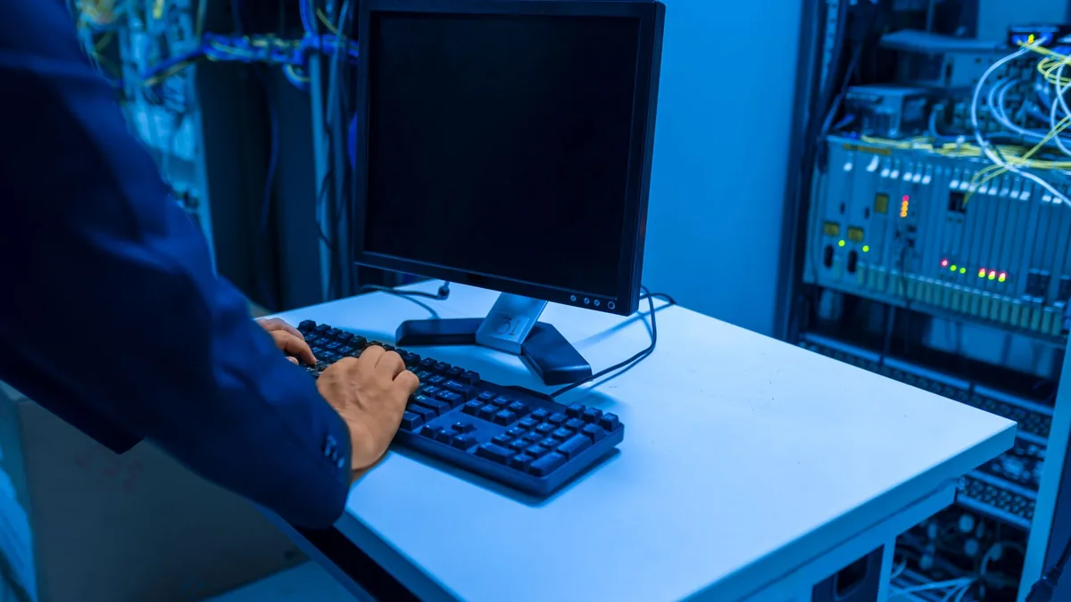 An it professional operates a computer in a server room