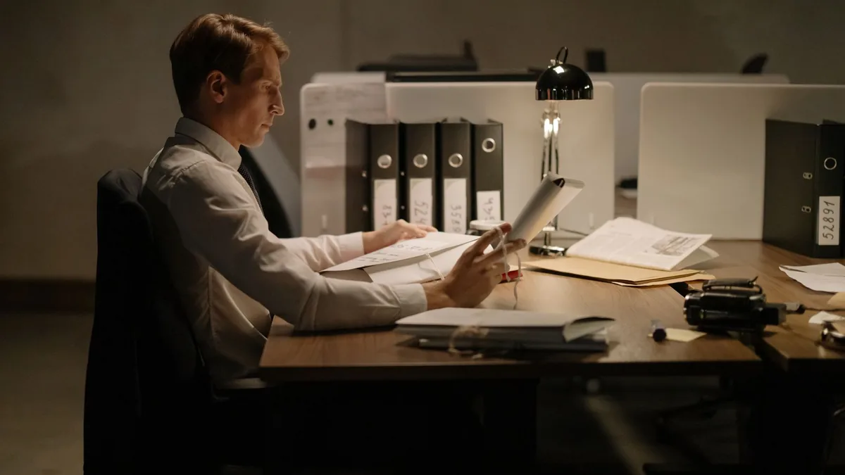 An office worker in formal attire intensely focused whil