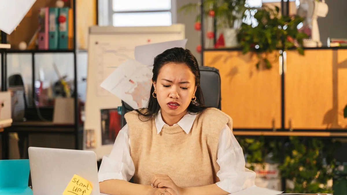 An office worker showing frustration while sitting at a