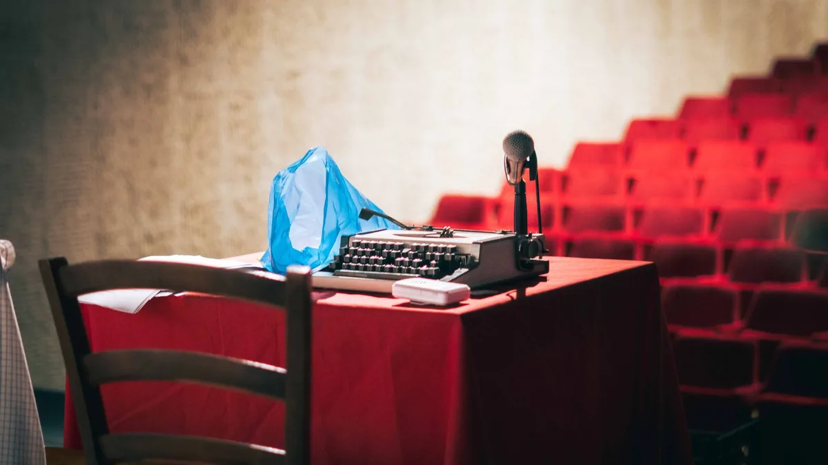 An old fashioned typewriter with a microphone on a theat