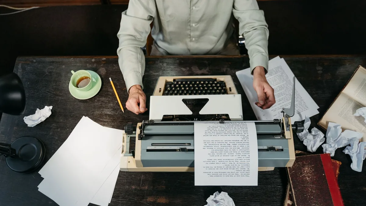 An overhead view of a workspace with a vintage typewrite