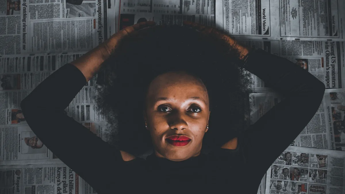 Artistic portrait of a woman with afro hair lying on new