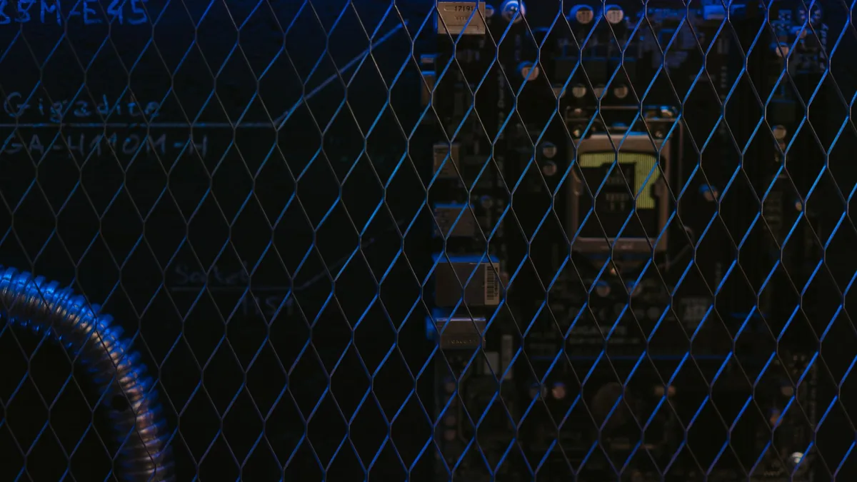 Artistic view of a circuit board through metal mesh with