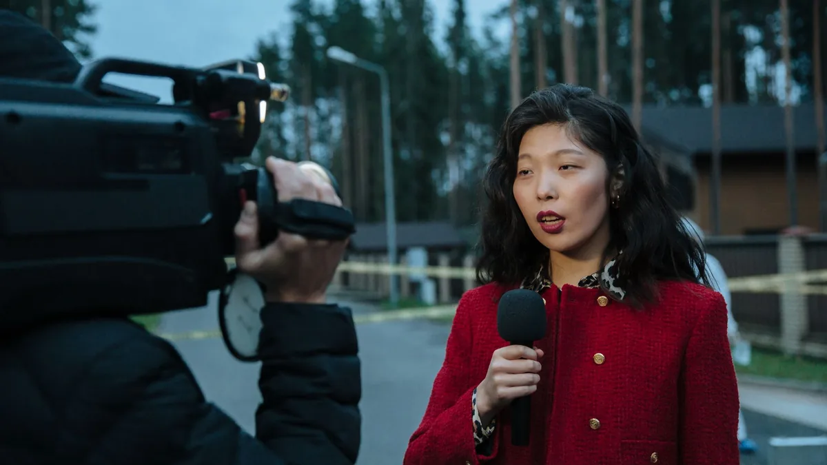 Asian female journalist reporting live from a suburban c