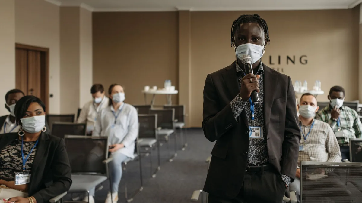Business conference with participants wearing masks disc