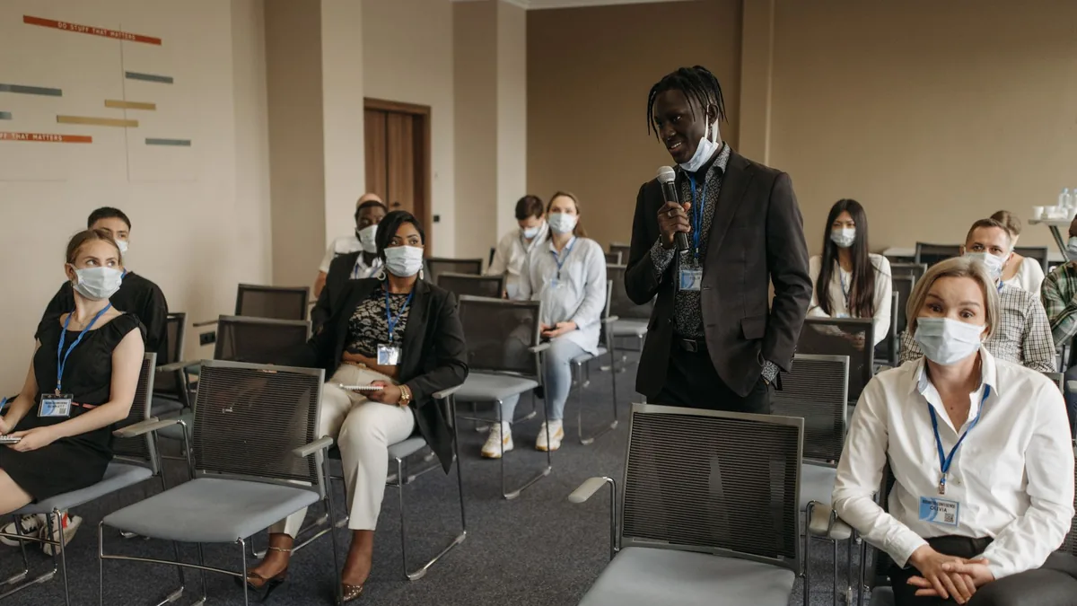 Business meeting with diverse participants wearing masks