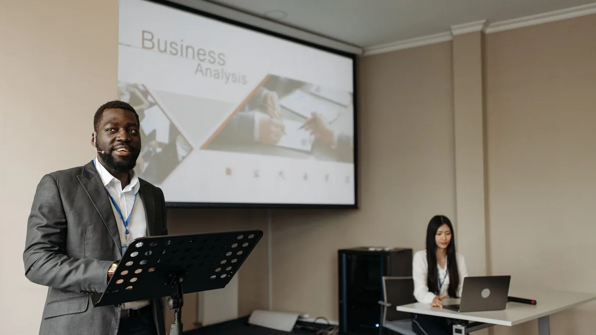 Business professionals presenting with projector and lap