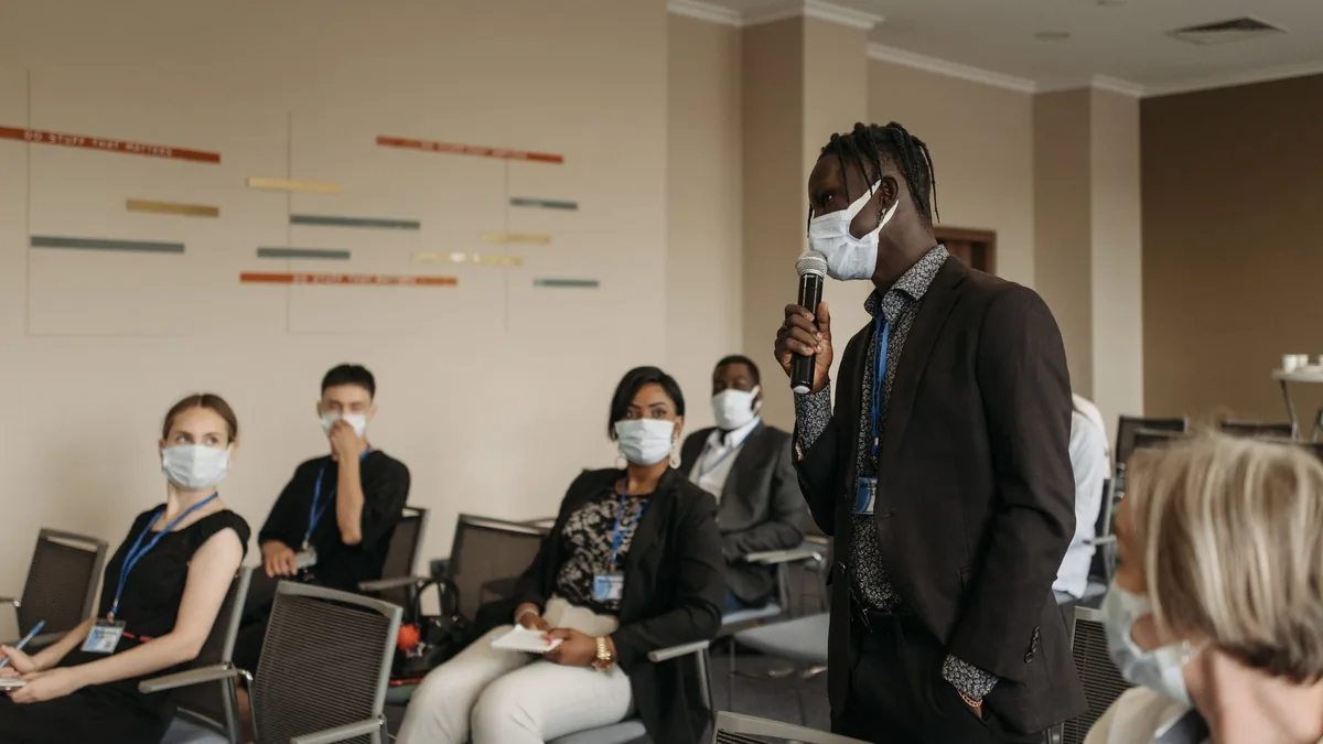 Business seminar with participants wearing face masks ac