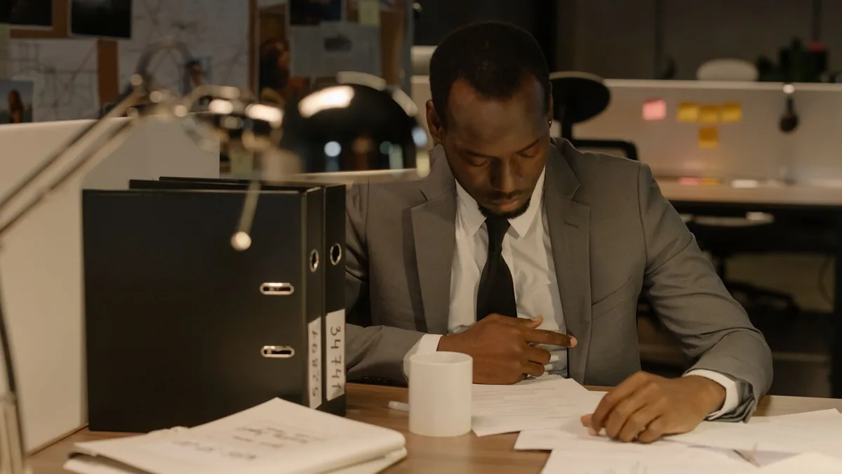 Businessman focused on paperwork at his desk in a modern