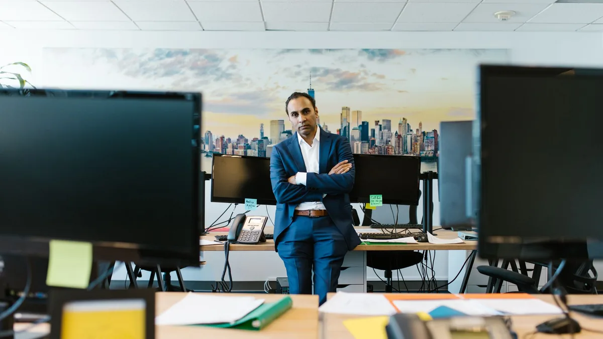 Businessman in a suit stands confidently in a modern off