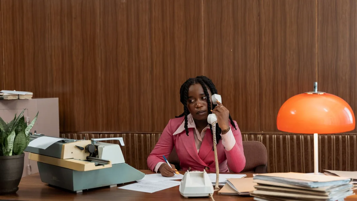 Businesswoman in retro office attire on phone call with