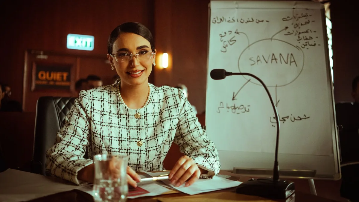 Businesswoman presents strategy on whiteboard in an offi
