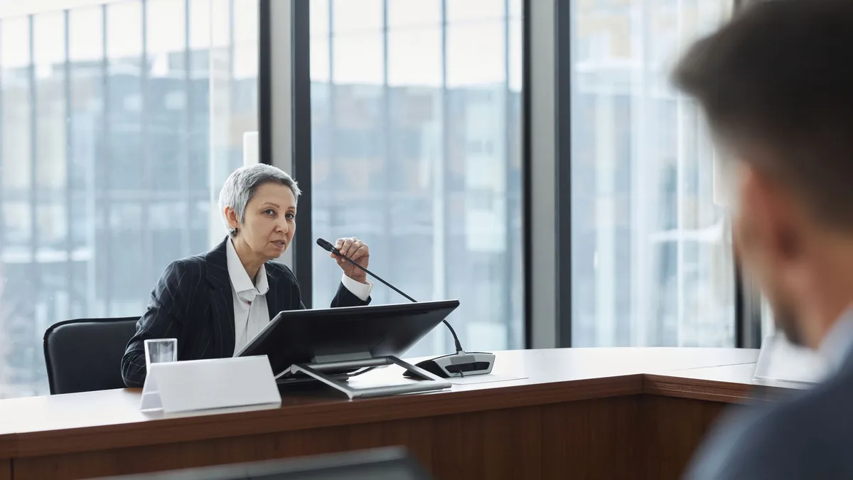 Businesswoman speaking at a corporate meeting in a moder