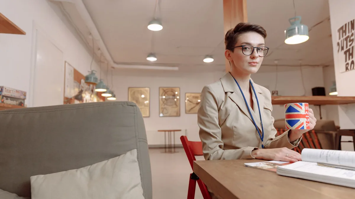 Businesswoman with union jack mug in a modern office set