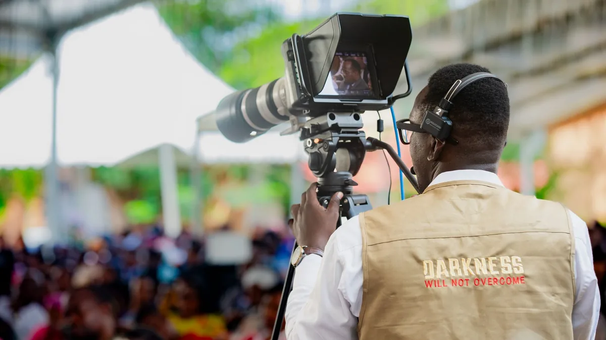 Cameraman filming an outdoor event in dar es salaam tanz