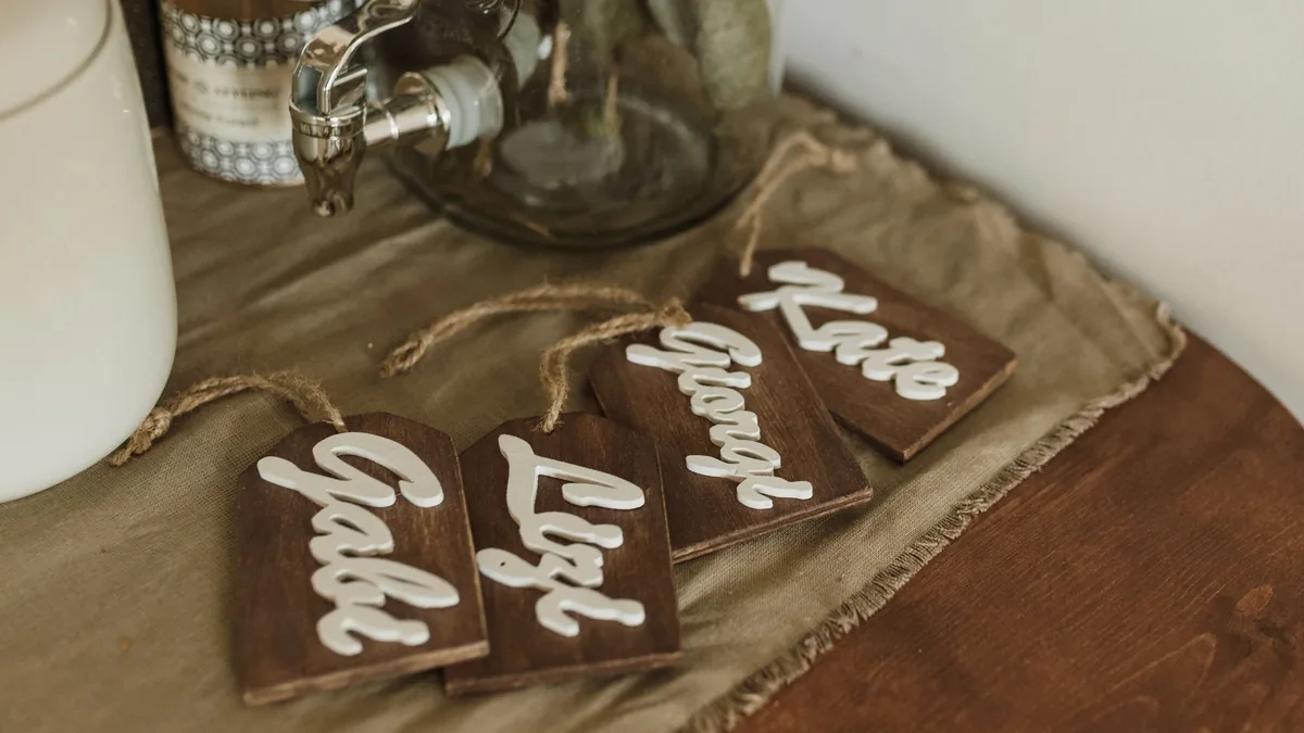 Charming wooden name tags with elegant script on a rusti