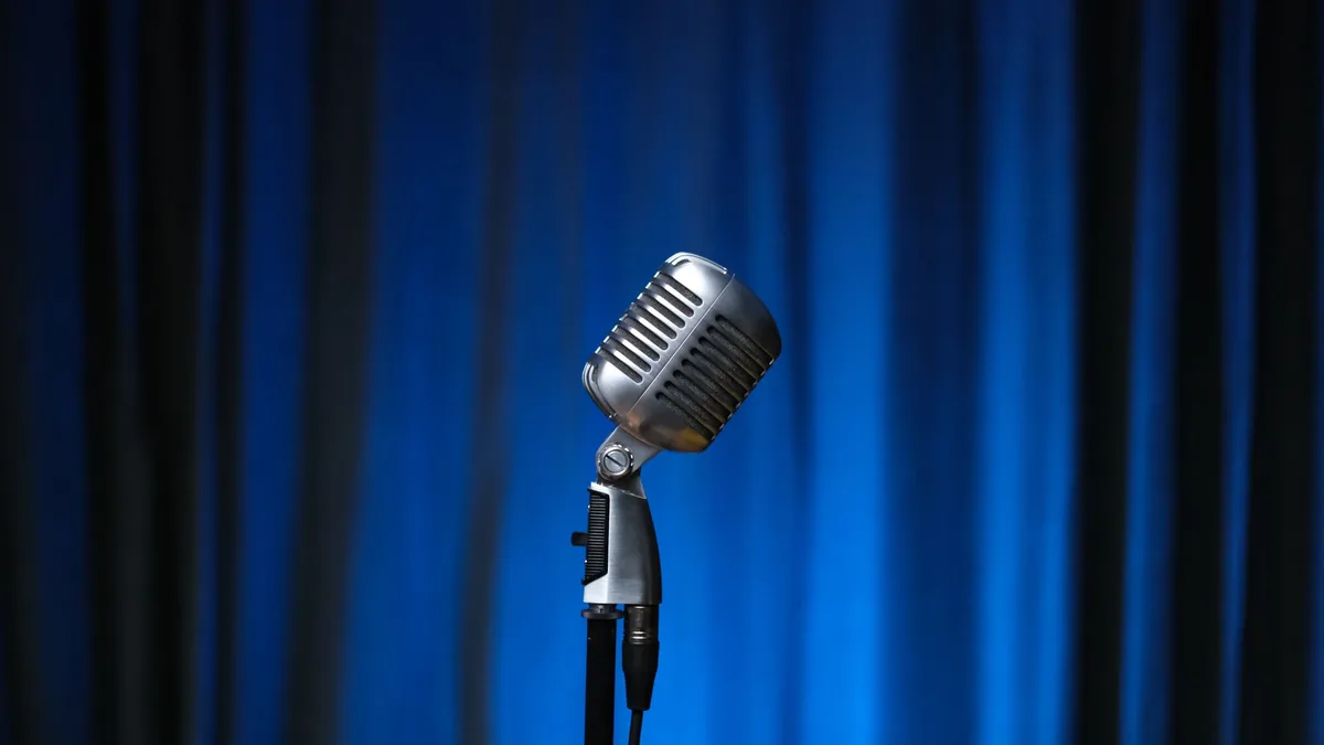 Classic microphone with vintage style against blue stage