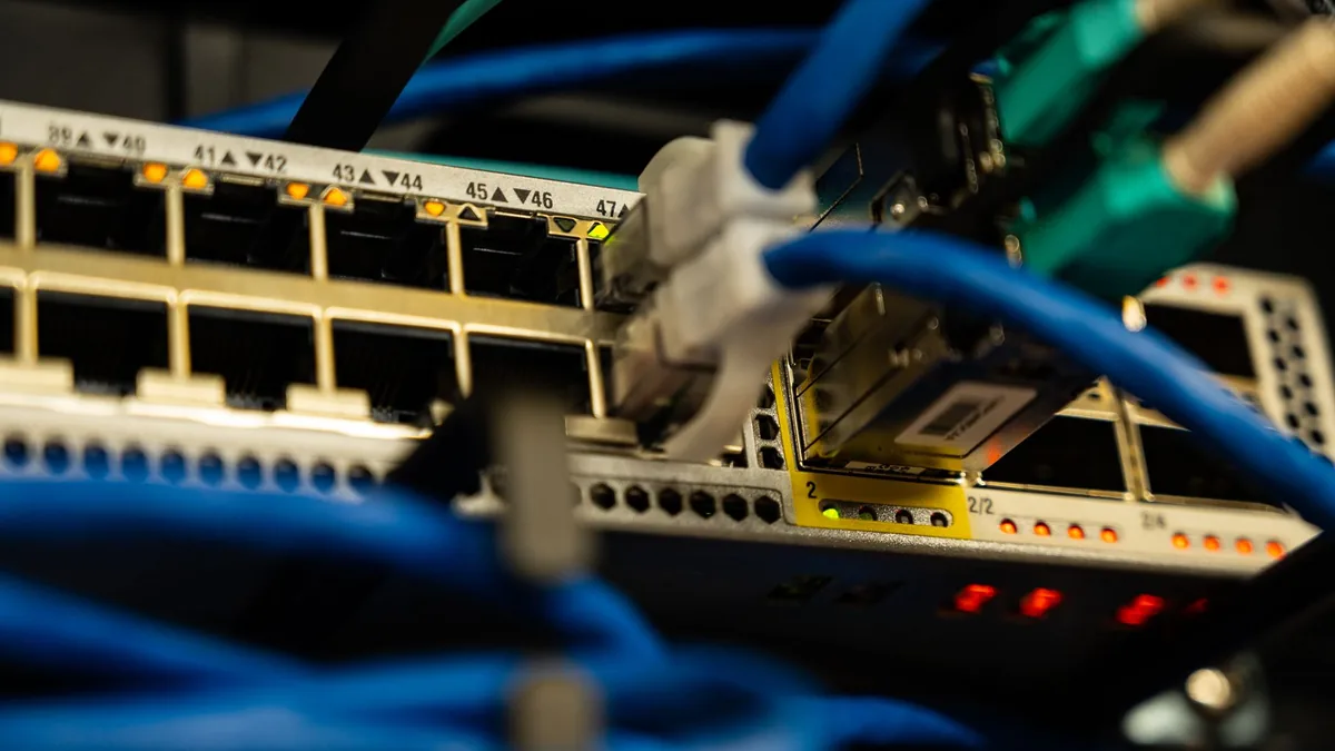Close up image of ethernet cables plugged into a network
