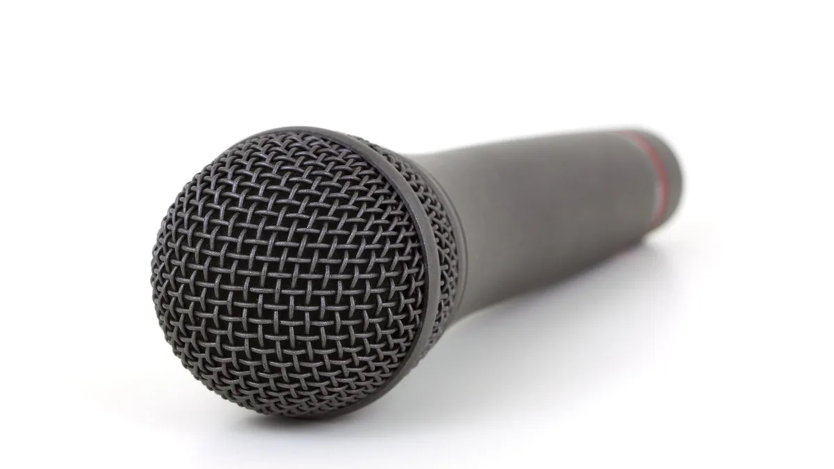 Close up of a black microphone on a white background ide
