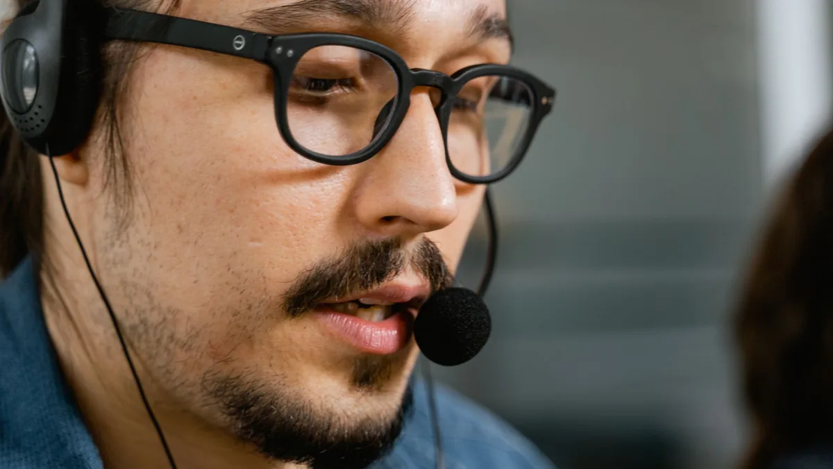 Close up of a call center agent with a headset and eyegl