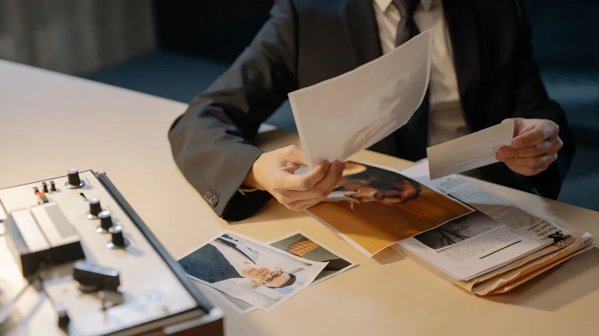 Close up of a detective in a suit analyzing photographic